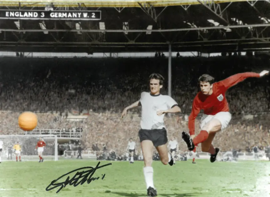 A signed photo of Geoff Hurst striking the ball in the 1966 World Cup Final.